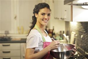 Woman in kitchen stirring