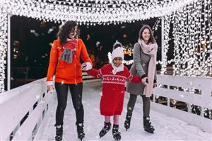 Two women and a girl ice skating