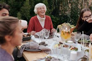 older woman at an outdoor dinner party