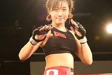 Female MMA fighter ready in the ring